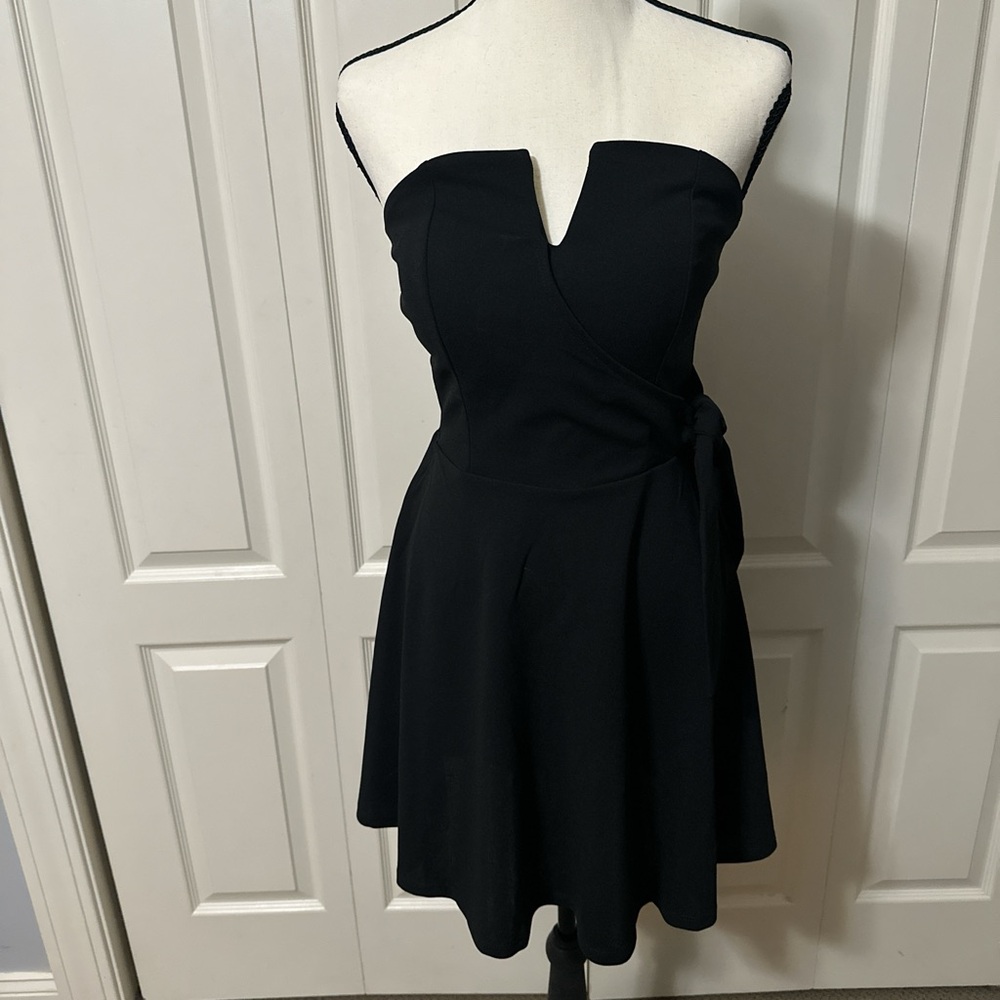 Black strapless mini dress with back zipper and decorative tie on side